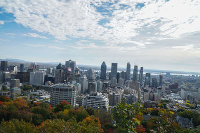 View of cityscape against cloudy sky
