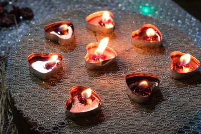 High angle view of lit candles