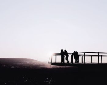 Silhouette friends standing at observation point