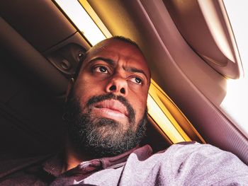 Man looking through airplane window 