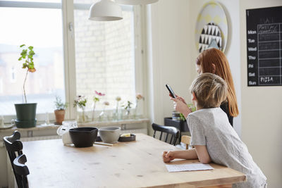 Children using phone while baking