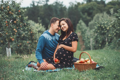 Smiling young woman with fruits in basket