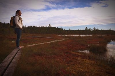 Full length of man walking on field against sky