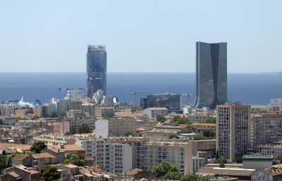 Modern buildings in city against clear sky