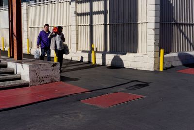 Men standing on sidewalk in city