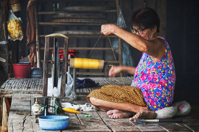 Woman working on loom