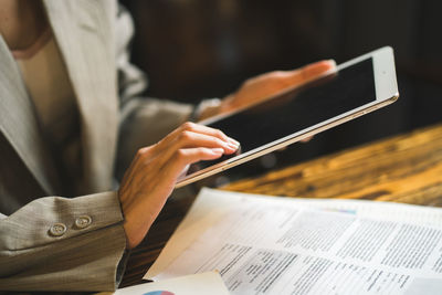 Midsection of man working on table