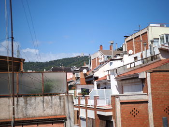 Residential buildings against blue sky