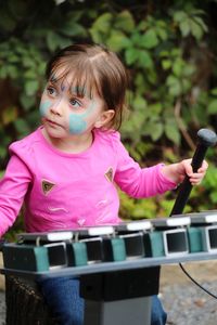 Innocent girl playing xylophone