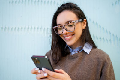 Portrait of young woman using mobile phone