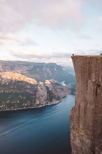 Man sitting at edge of cliff at preikestolen, norway