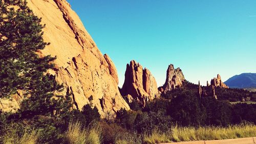 Scenic view of mountains against clear blue sky