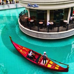 High angle view of people on boat in canal