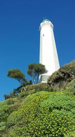 Low angle view of lighthouse against clear blue sky