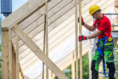 Low angle view of man standing by building