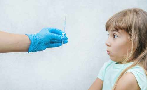 Side view of woman holding syringe