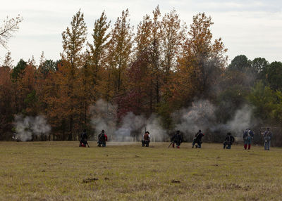 Group of people on field during autumn