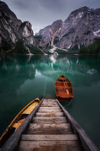 Scenic view of lake by mountains against sky