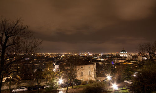 Illuminated city against sky at night