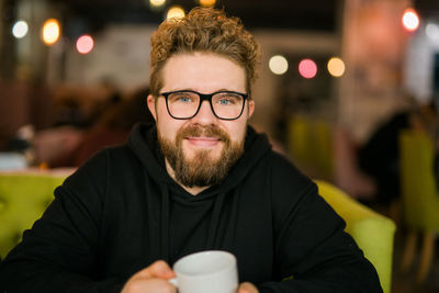 Portrait of young woman having coffee