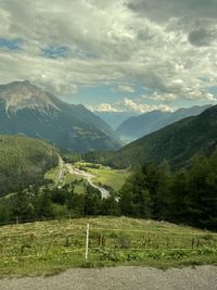 Scenic view of field and mountains against sky