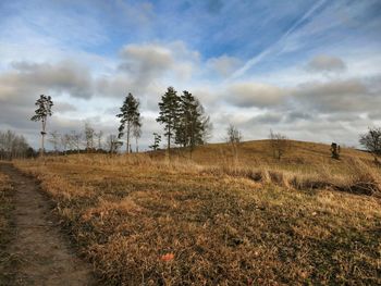 Scenic view of field against cloudy sky