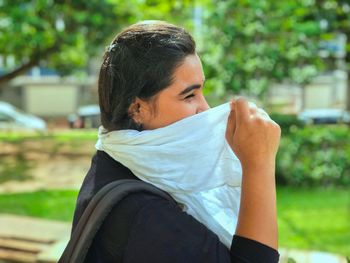 Young woman holding scarf