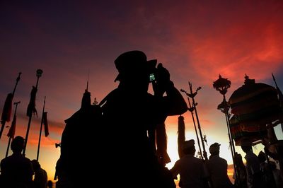 Silhouette of people at sunset