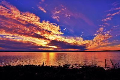 Scenic view of sea against romantic sky at sunset