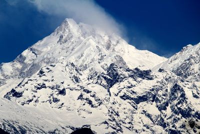 Scenic view of snow covered mountains against sky