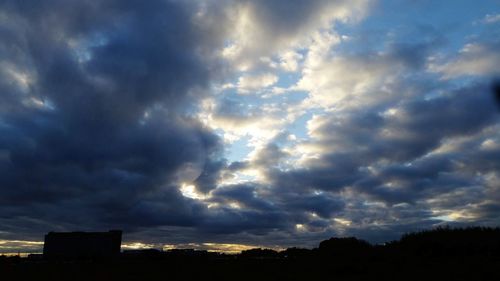 Low angle view of storm clouds over city