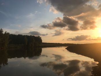 Scenic view of lake against sky during sunset