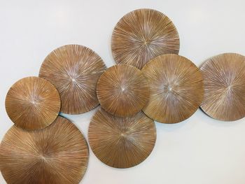 Close-up of carvings on table against white background