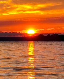 Scenic view of sea against romantic sky at sunset