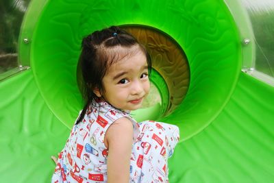 Portrait of cute girl turns around and prepares to sliding down