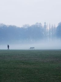 Man on field against sky