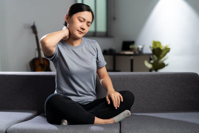 Portrait of young woman exercising at gym