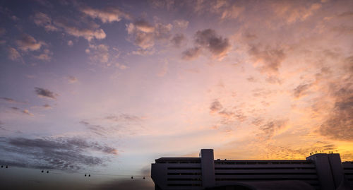 Low angle view of building against cloudy sky