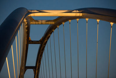 View of illuminated bridge against blue sky