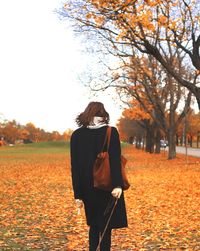 Woman standing on field during autumn
