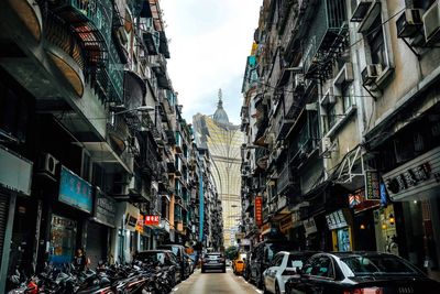 Street amidst buildings in city against sky