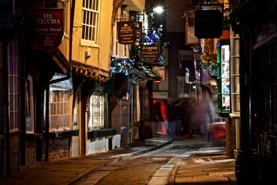 Illuminated city street at night