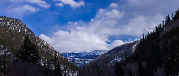 Panoramic view of snowcapped mountains against sky