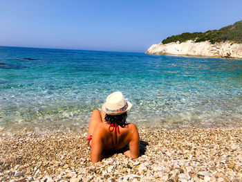 Woman with bikini sitting close to the beach.ionian sea albania