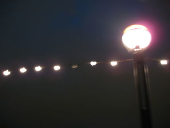 Low angle view of illuminated street light at night