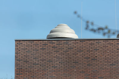 Low angle view of building against clear blue sky