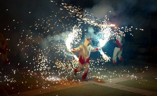 People watching firework display at night