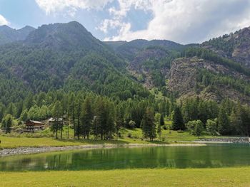 Scenic view of lake and mountains against sky