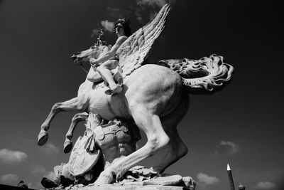 Low angle view of statue against sky