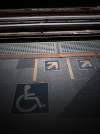 High angle view of wheelchair access sign at railroad station